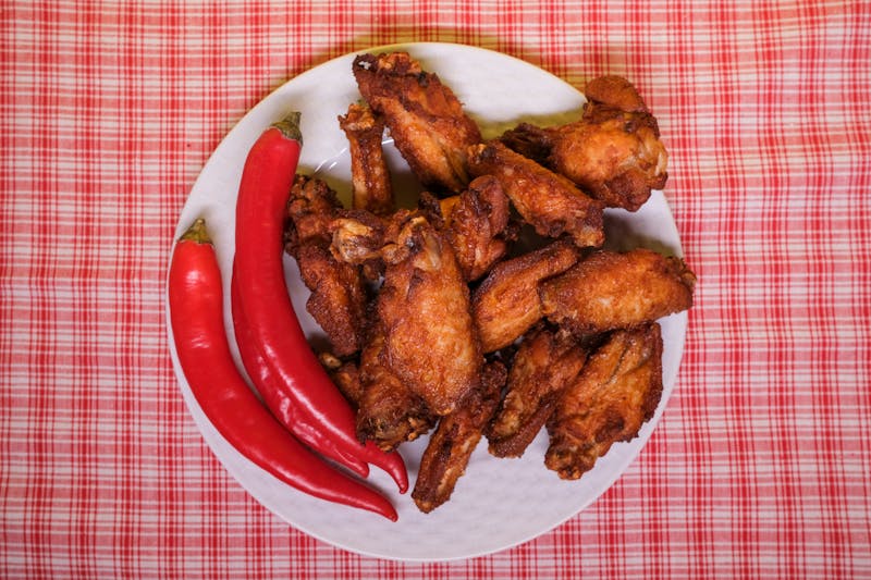 Smoked BBQ wings on a platter at Wing Snob with rich sauce