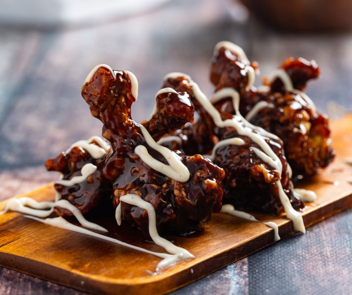 Parmesan Ranch boneless wings coated in cheesy herb sauce